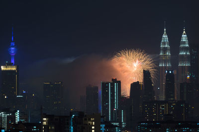 Low angle view of firework display at night