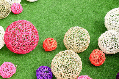 High angle view of colorful straw balls on grass