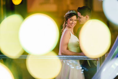 Young couple embracing against glowing light