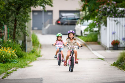 Boy riding bicycle on road in city