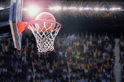 Close-up of basketball hoop at night