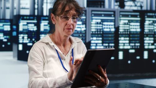 Young woman using laptop while sitting at airport