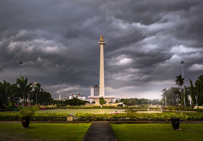 View of monument in city against cloudy sky