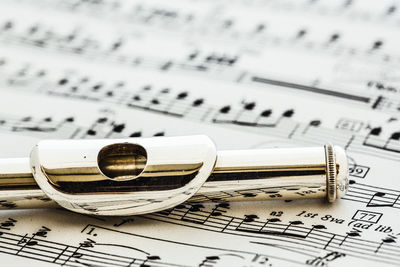 Close-up of woodwind instrument on sheet music