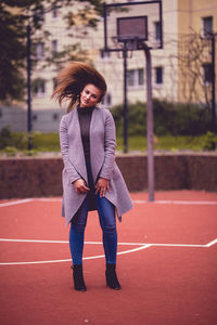 Portrait of beautiful young woman standing outdoors