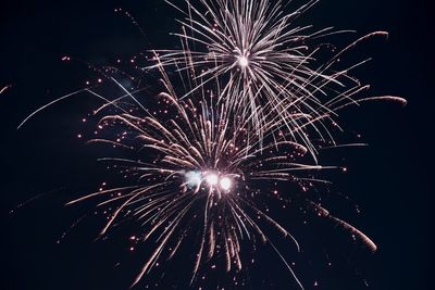 Low angle view of firework display at night