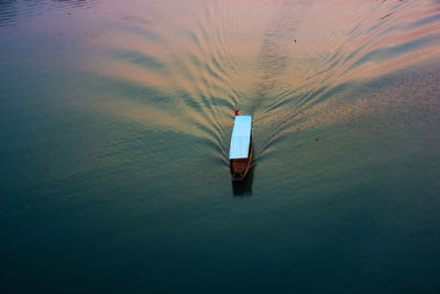 High angle view of boat in sea during sunset