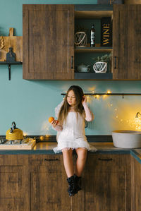 Cute baby in the kitchen. christmas or new year. with tangerines.