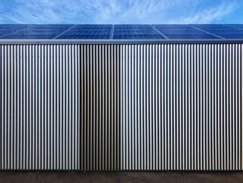 Full frame shot of factory against blue sky