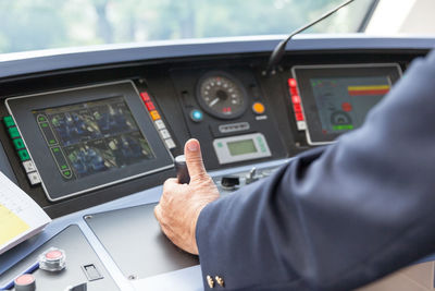 Cropped hand of man driving vehicle