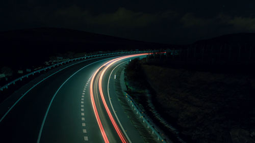 High angle view of light trails on road at night