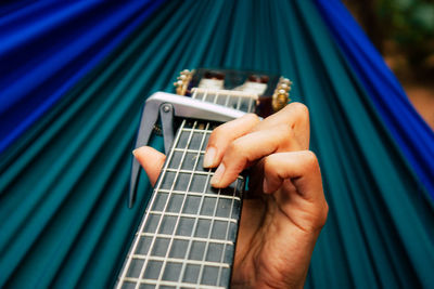 Close-up of person playing guitar