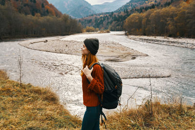 Rear view of woman standing on land