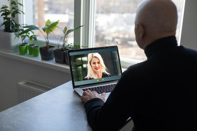 Midsection of man using digital tablet in office