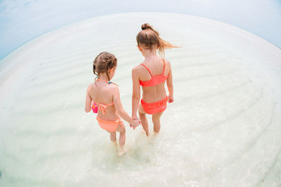 Rear view of women in water