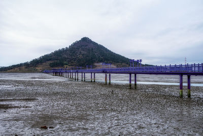 Pier over sea against sky