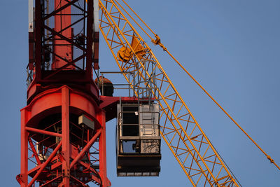 Low angle view of crane against clear sky