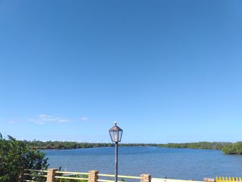 Scenic view of river against clear blue sky