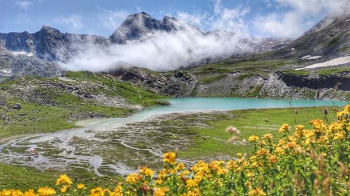 Scenic view of lake and mountains against sky