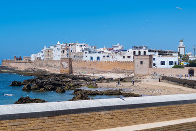 Buildings by sea against blue sky, essaouira, morocco