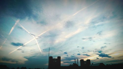 Low angle view of buildings against cloudy sky