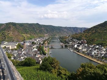 High angle view of river amidst buildings against sky