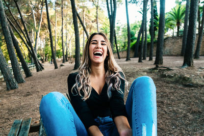 Portrait of smiling young woman sitting outdoors