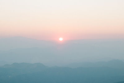 Scenic view of silhouette mountains against sky during sunset
