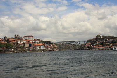View of city by sea against sky