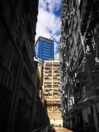 Low angle view of skyscrapers against blue sky