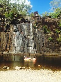 Scenic view of waterfall against sky