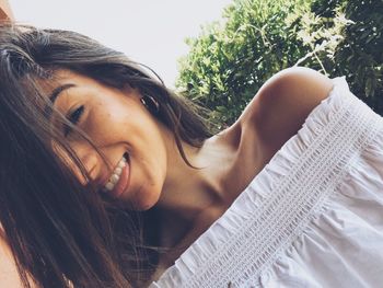 Close-up portrait of happy young woman at park