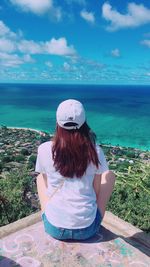 Rear view of woman looking at sea against sky