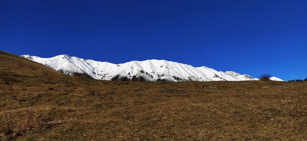 Scenic view of snowcapped mountains against clear blue sky, italianalps