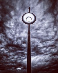 Low angle view of street light against cloudy sky