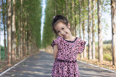 Portrait of young woman standing in forest