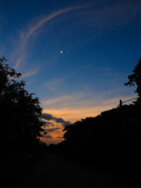 Low angle view of silhouette trees against sky at sunset