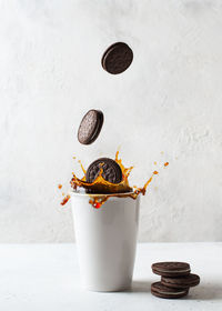 Close-up of coffee cup on table against wall