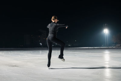 Full length of woman jumping on stage