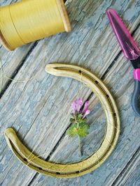 High angle view of pink flowering plant in basket on table