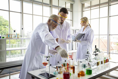 Female doctor examining chemical in laboratory