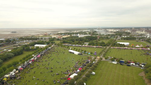 High angle view of crowd in city against sky