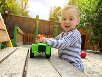 Portrait of cute boy playing with toy car