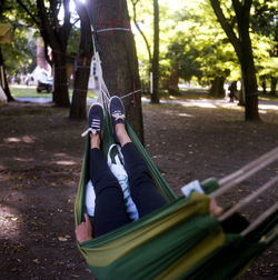 Person relaxing on hammock in park