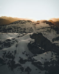 Scenic view of snowcapped mountains against sky during sunset