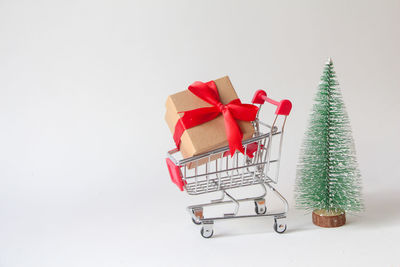 High angle view of shopping cart against white background