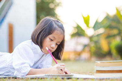 Portrait of girl sitting on table