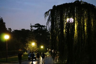 Woman standing on illuminated street light