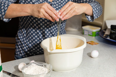 Midsection of woman preparing food in kitchen