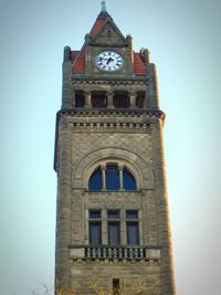 Low angle view of clock tower against sky